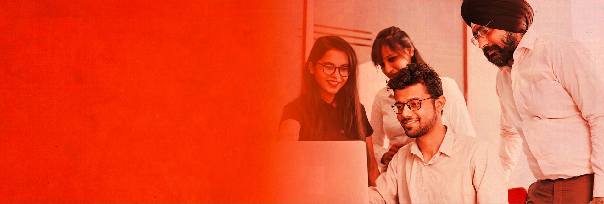 A group of colleagues looking at laptop