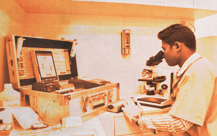 Scientist using microscope in health research