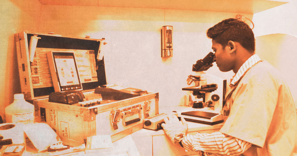 Scientist using microscope in health research