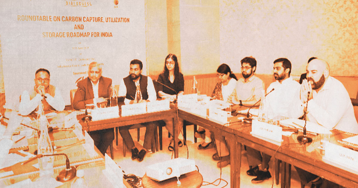 Group of people sitting at table for earth dialogue roundtable