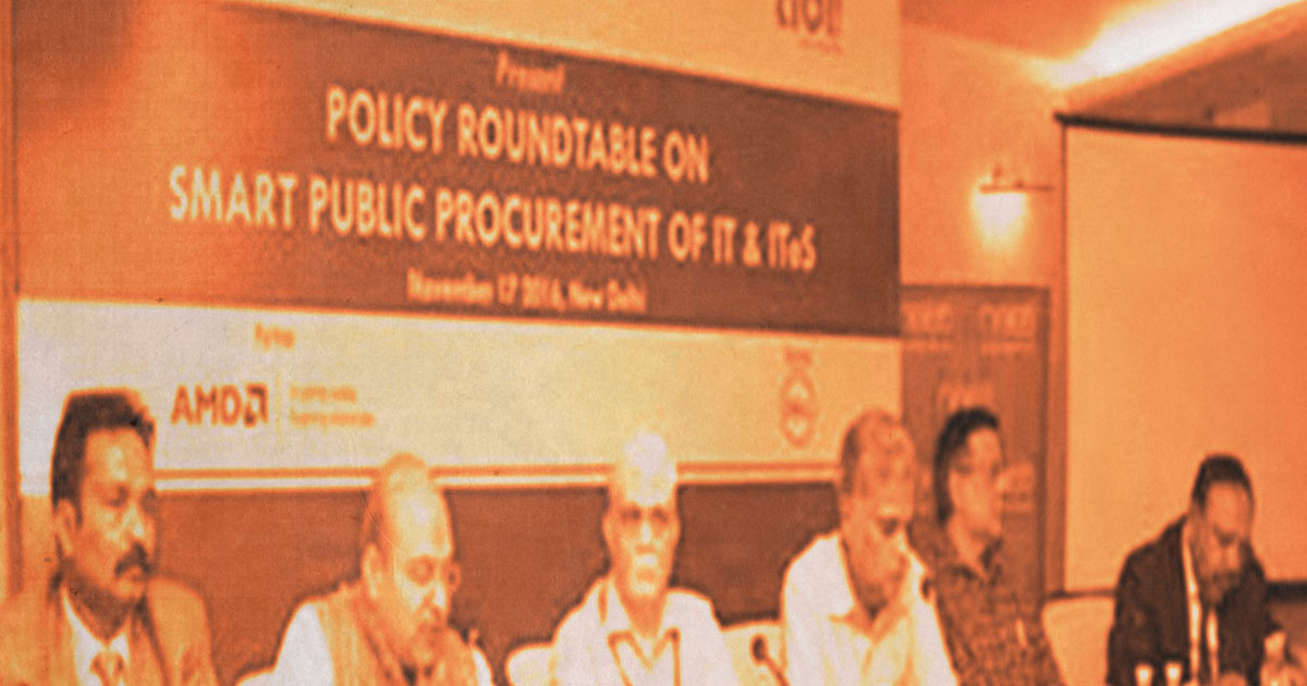 Group of men in front of event banner on smart public procurement of IT and ITeS